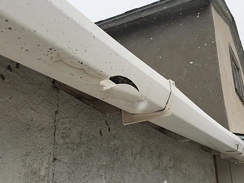 vinyl gutter damaged from hail